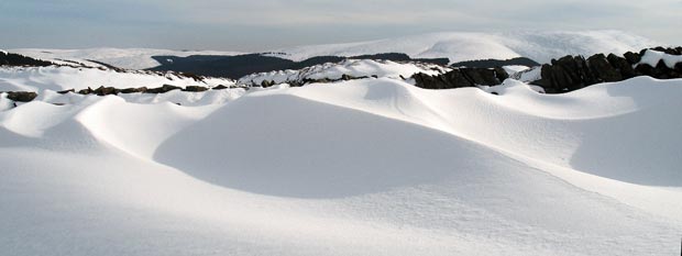Snow sculptures along the dyke with Ettrick Pen in the distance