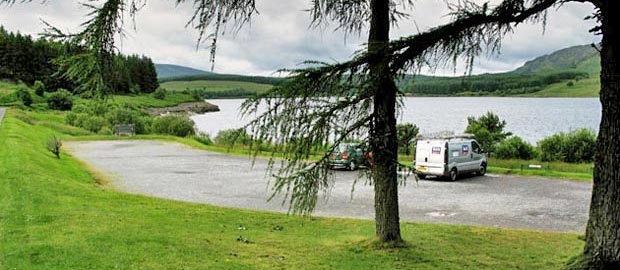 View of the car park at the visitor's centre by Clatteringshaws Loch.