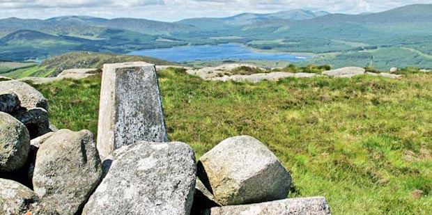 View looking north west over Clatteringshaws to Merrick from the cairn and trig point at the top of Cairnsmore of Dee.
