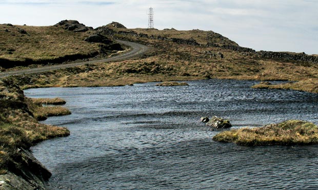 View over a lochan back to the mast on Bennan