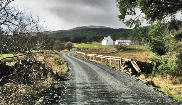 View of the house at Burnhead with the top of Meikle Millyea showing in the distance