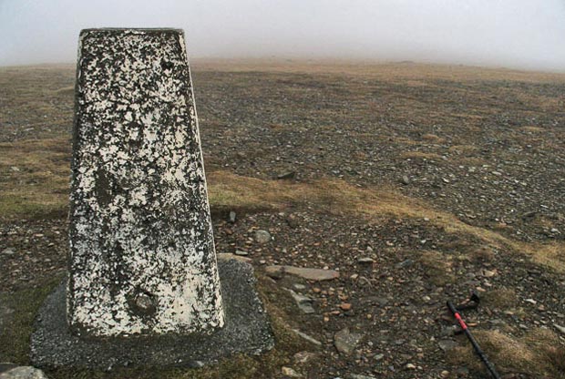 View of the trig point on the top of Corserine in mist