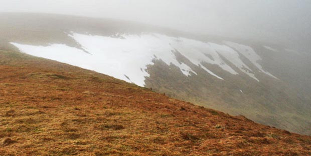 View through mist of the ridge that runs down to Carlin's Cairn from Corserine