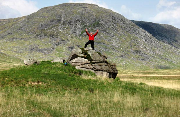 Sandy on the rock outcrop near Craignaw with Dungeon Hill beyond