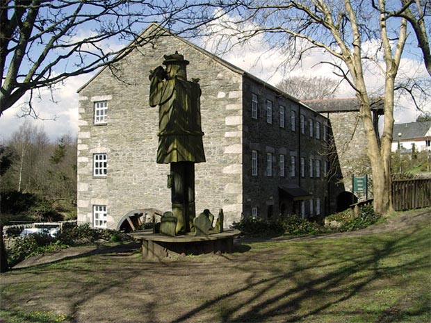 Large wooden sculpture of a bird watcher by Mill on the Fleet