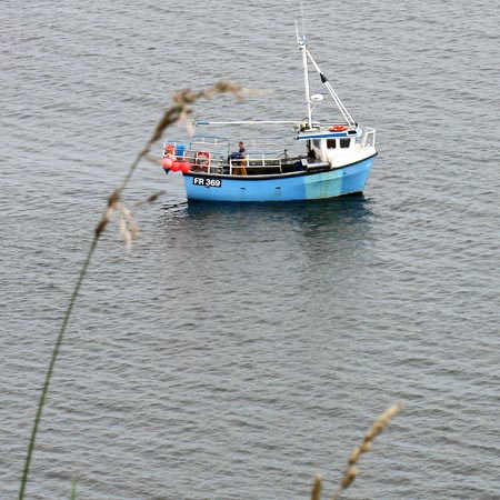 Fishing boat close in on Cruggleton Castle