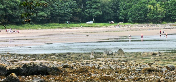 Holidaymakers on the beach at Rigg Bay