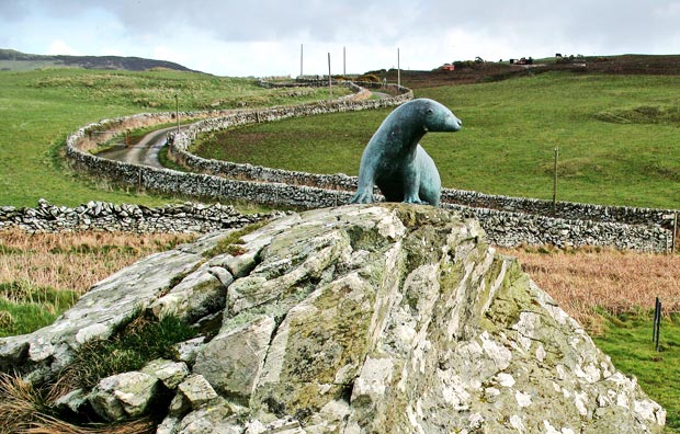 The otter memorial to Gavin Maxwell with the single track road going to the A747 in the background.