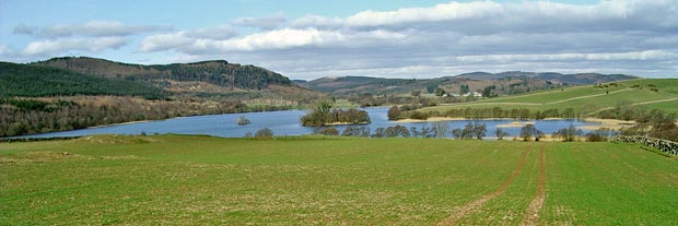 View of the crannog on Loch Kindar from the road to Ardwall from the A701