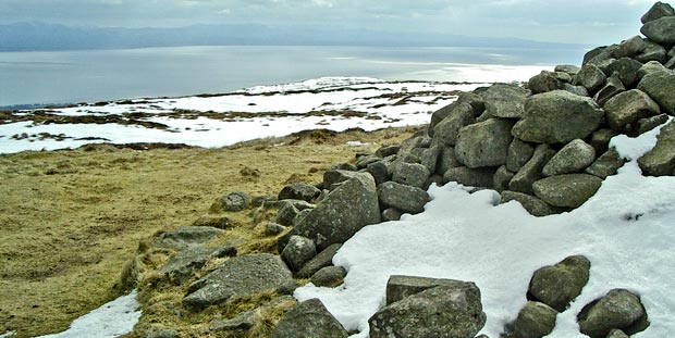 View of Douglas's cairn on the top of Criffel with the Solway Firth and the Lake District beyond