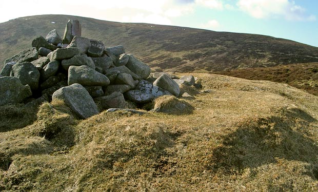 View of the cairn on the top of Knockendoch with Criffel beyond