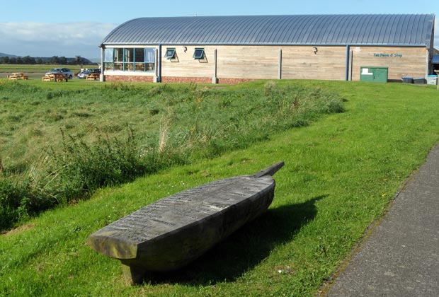 View of tearoom and shop on the pier at Glencaple with a seat in the form of a boat in the foreground