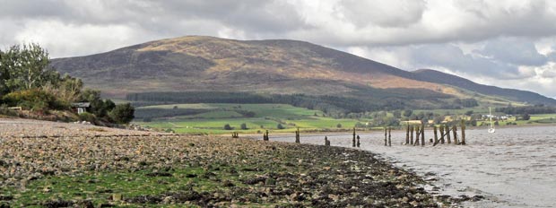 View of Criffel from the shore at Carsethorn with the remains of an old pier in the foreground