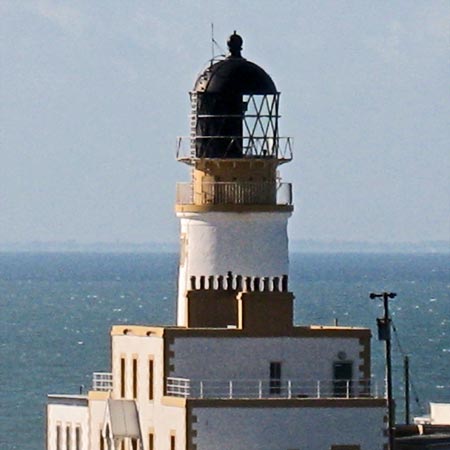 Detail of Killantringan lighthouse with Ireland just visible beyond it