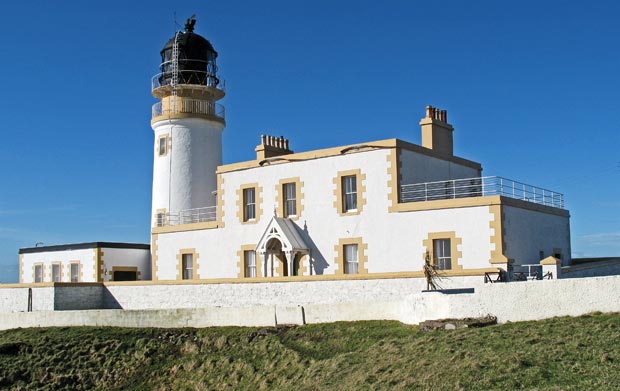 Looking north towards Killantringan lighthouse from the cliff over Portamaggie Bay