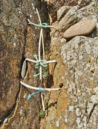 Driftwood cross and stones with messages
