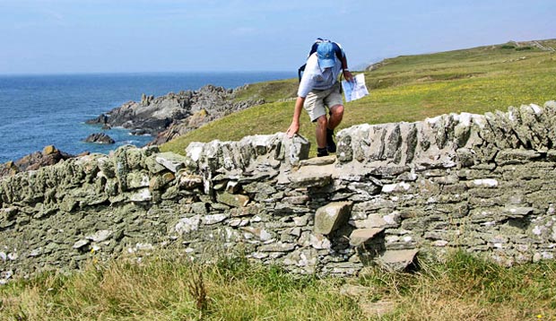 Stone dyke with stepping stones built into it on the cliff top path