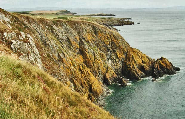 View over the last of the high cliffs towards Isle of Whithorn