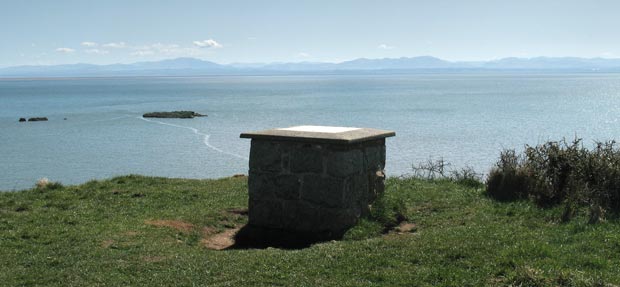 View of information board on top of Castle Point with the Solway Firth and the Lake District beyond.